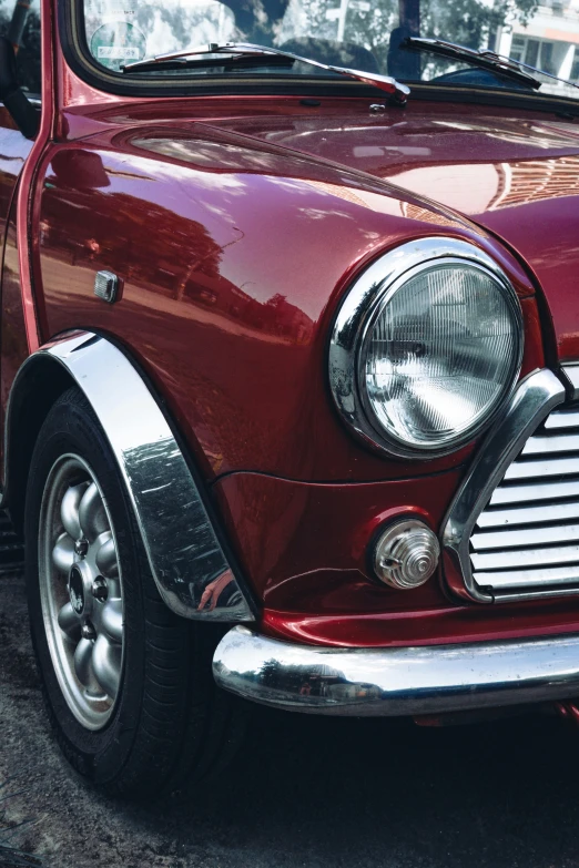 a small red car parked on the side of the road