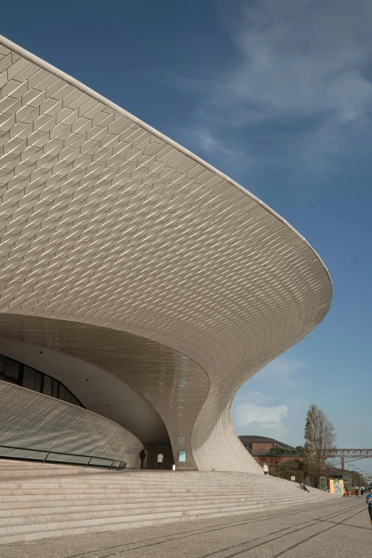 a man riding his skateboard past the modern building