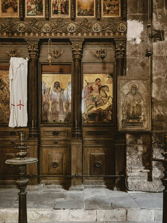 an empty room with an ornate alter and paintings on the walls