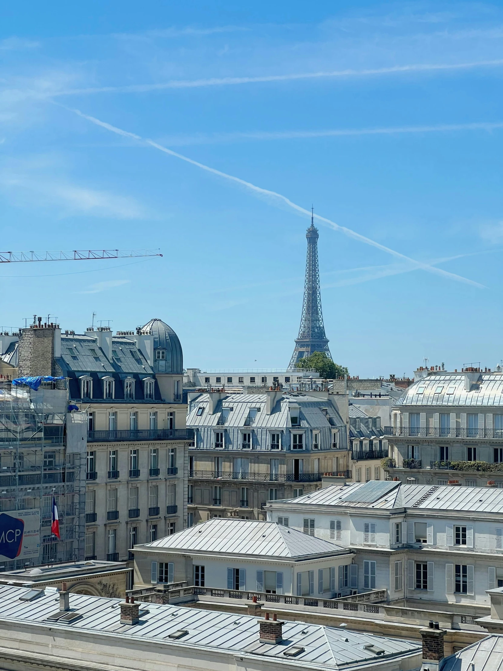 view from top of a roof looking out on the city and eiffel tower