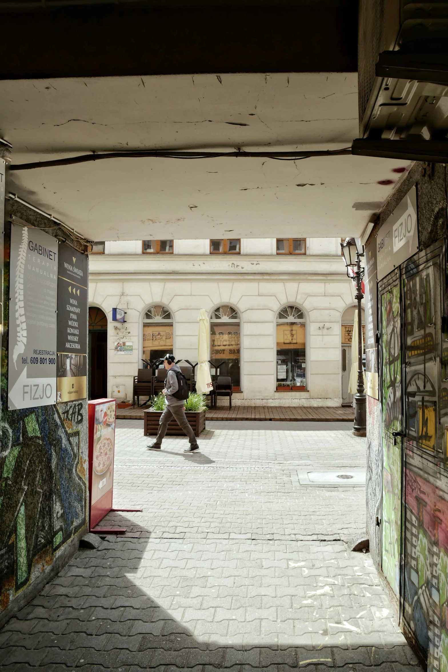 the courtyard has a lot of posters and old buildings