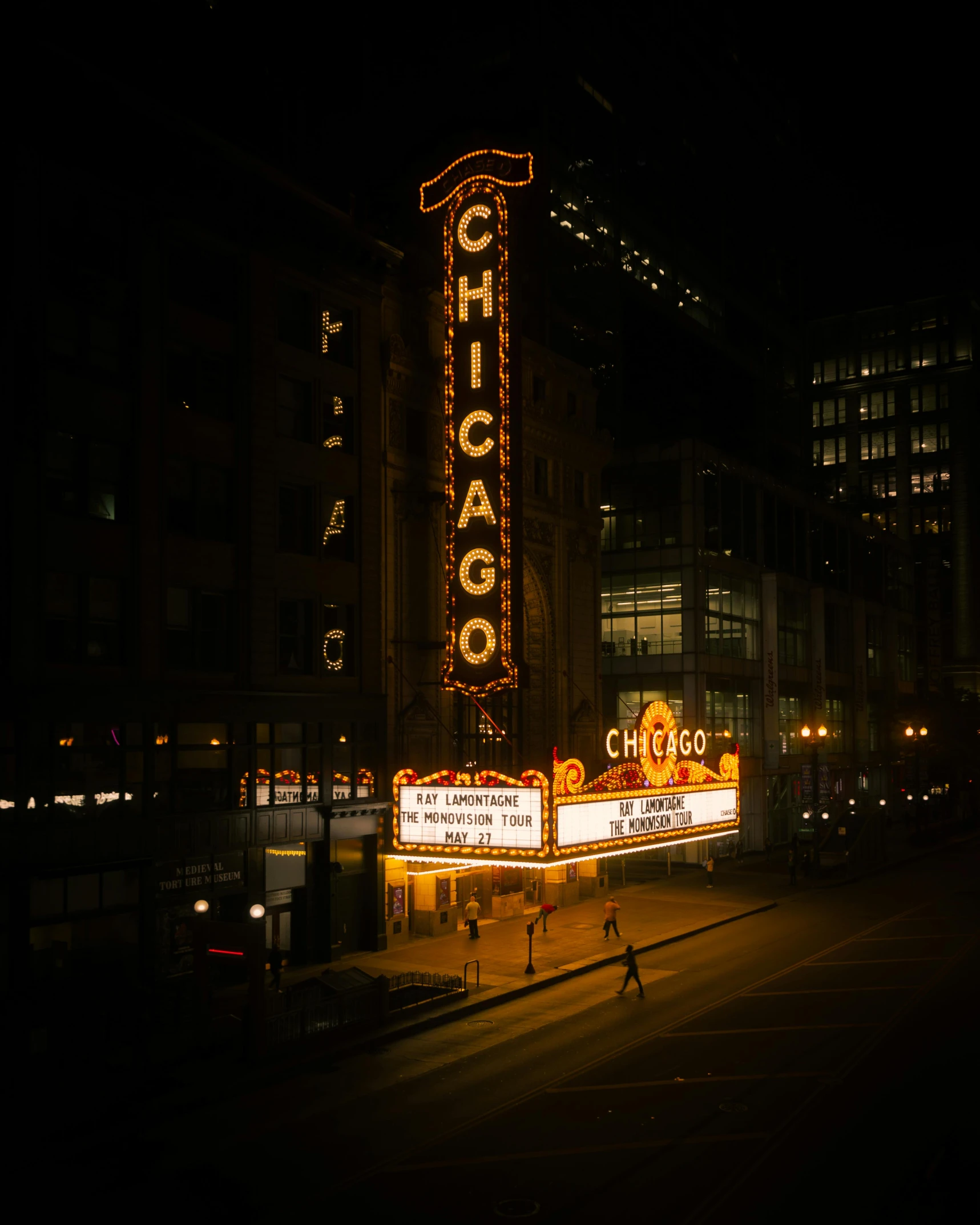 a neon sign on the side of a city street