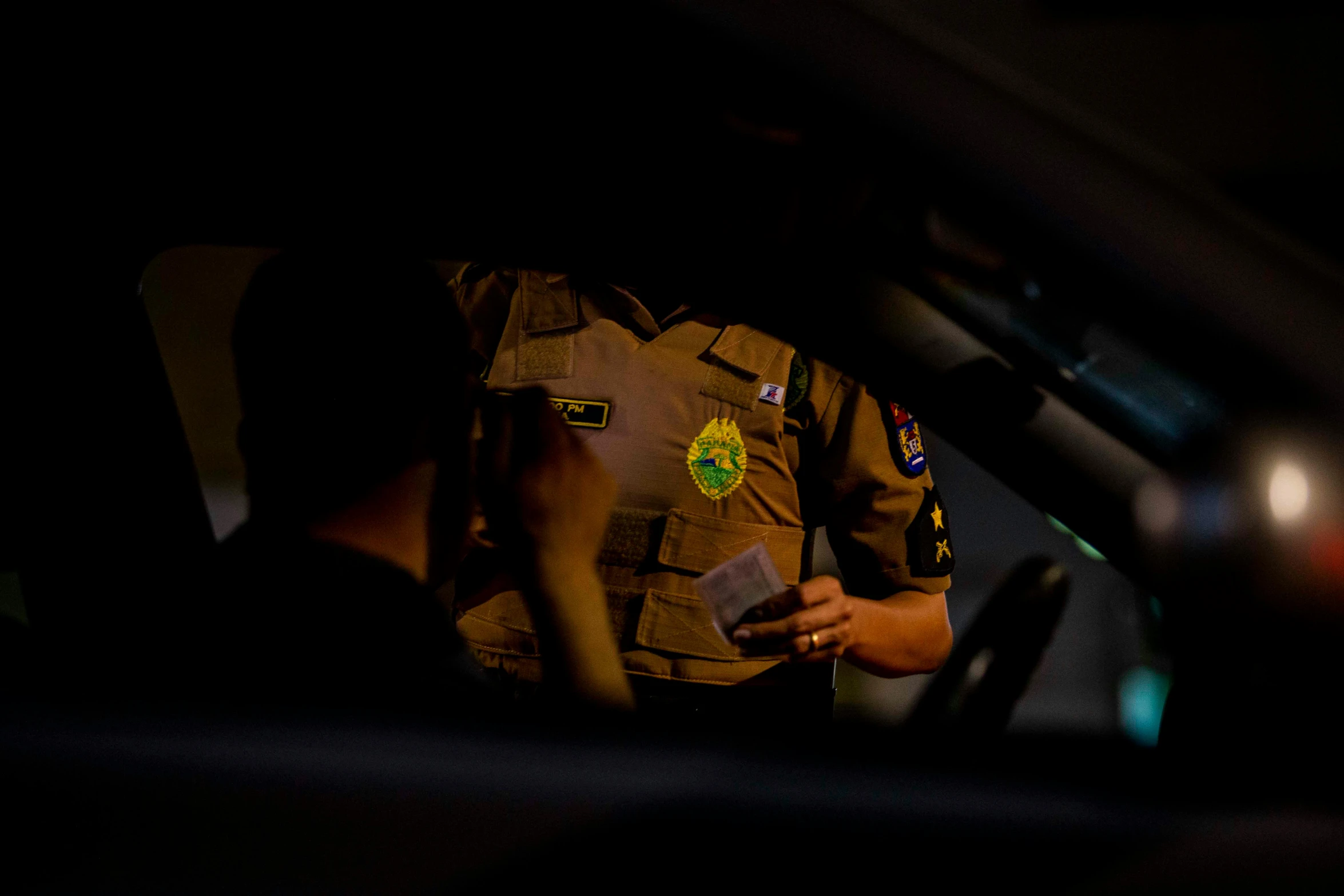 a cop is standing behind a car door