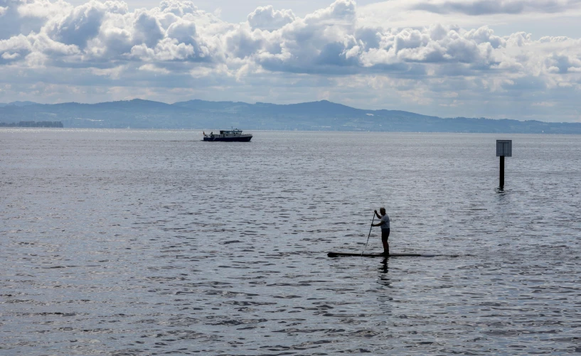 a paddle boarder is going down the water