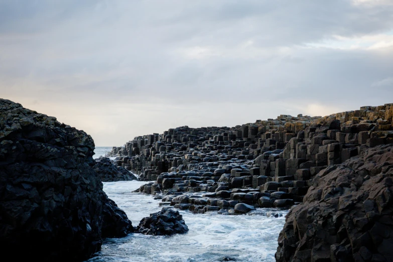 a rock beach filled with rocky cliffs and water