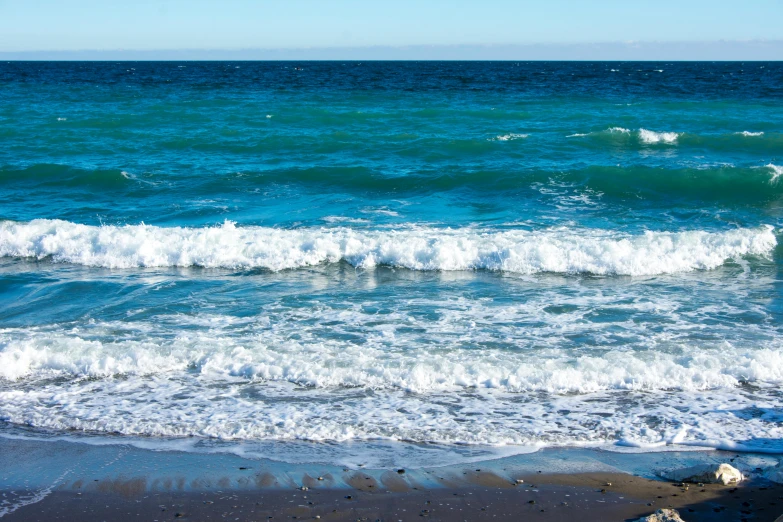 a po of a beach with a couple of people in it