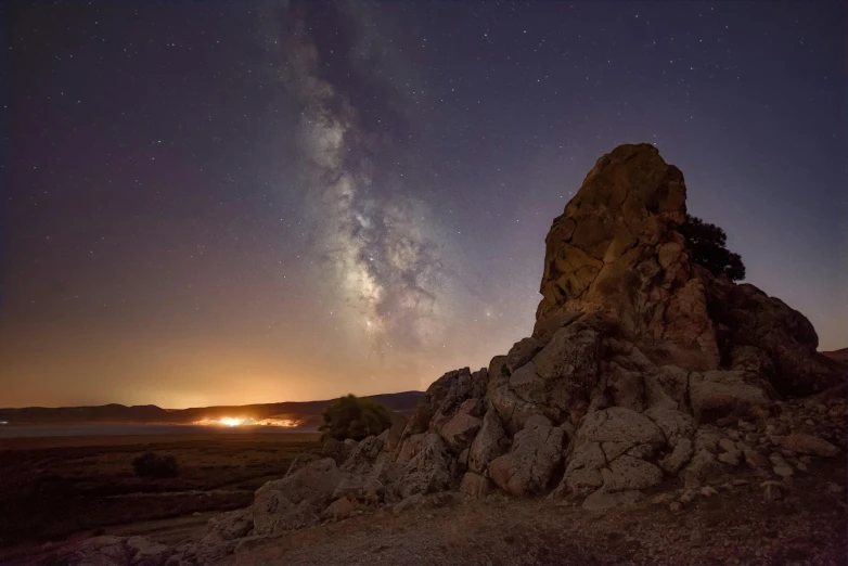 a dark sky is above some very large rocks