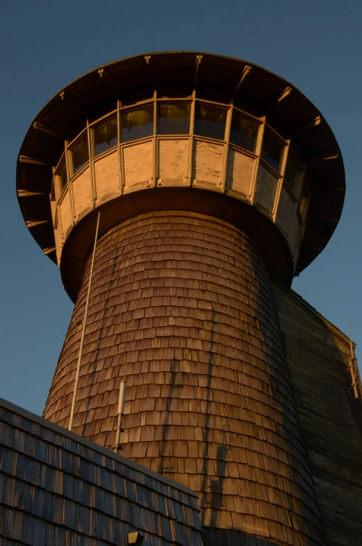 a tower with a metal roof and a weather vein