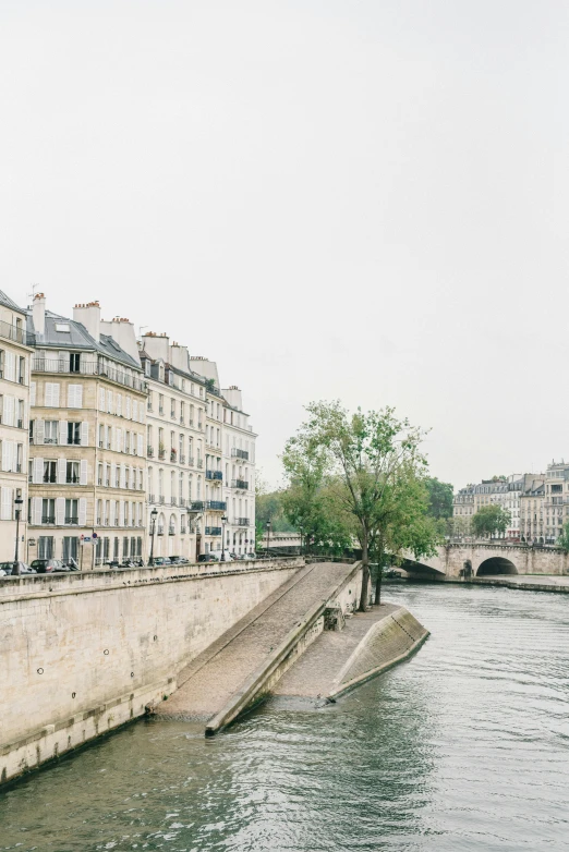 a large building sitting next to the side of a river