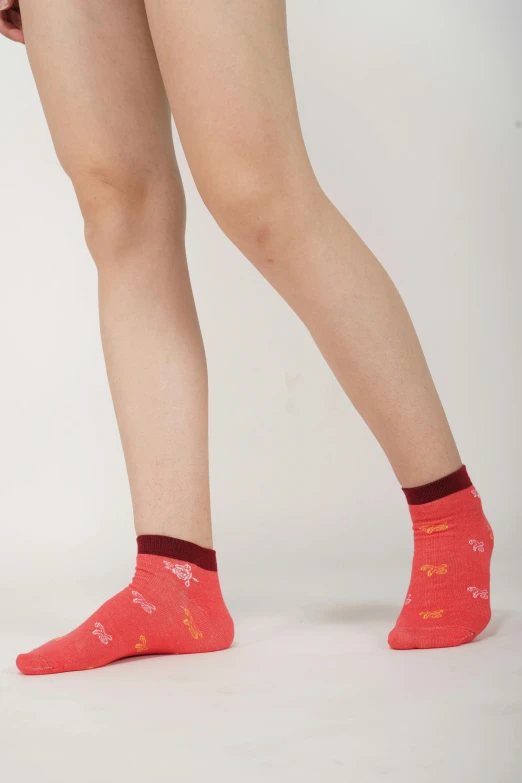 a person wearing orange socks and socks with orange accents