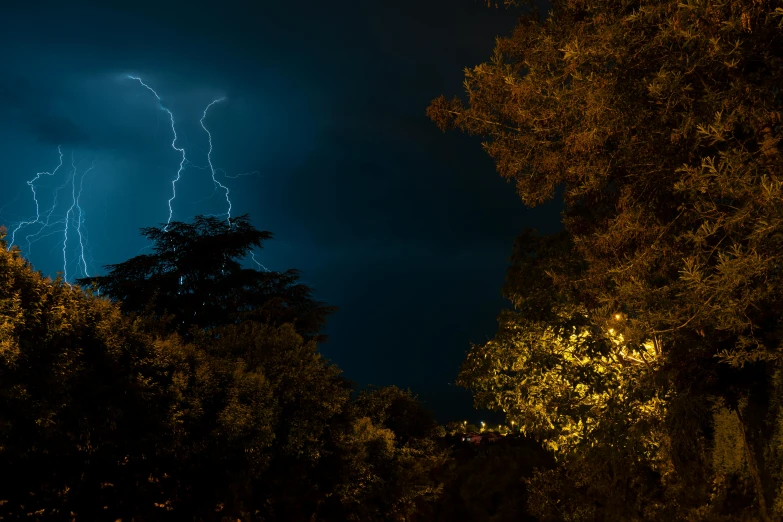 a lightning striking the sky over some trees