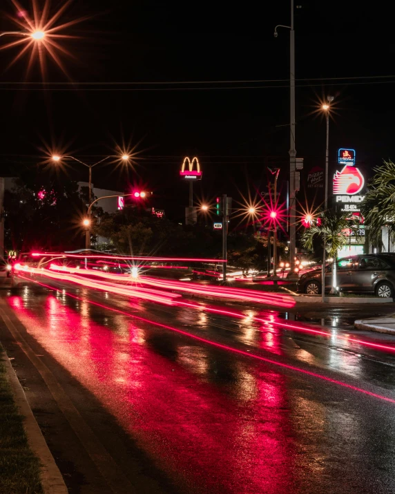 a city street with several cars moving along it