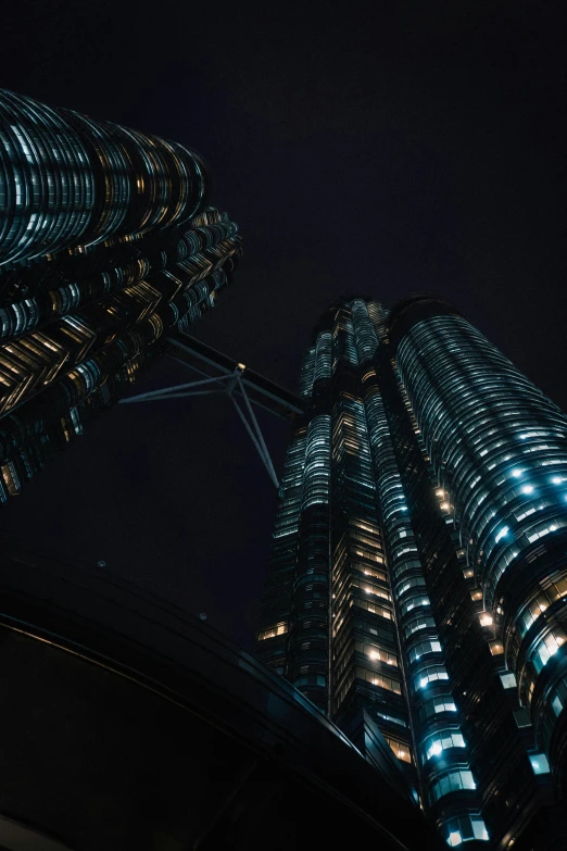 the view of some very tall buildings at night
