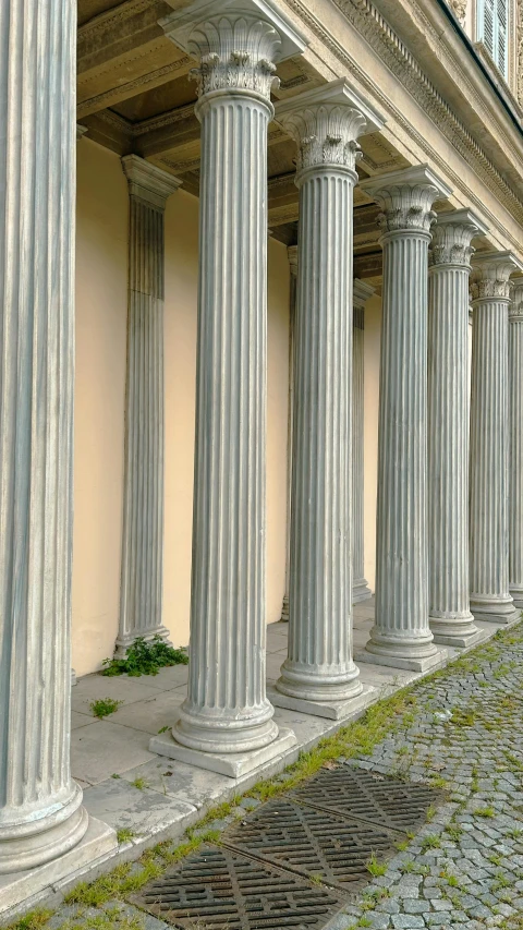 the exterior of an older building is covered in columns and pillars