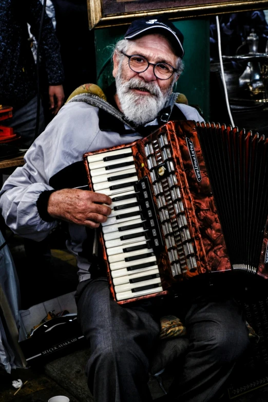 the man is sitting down with a instrument