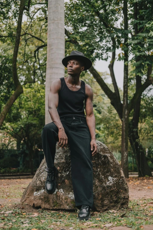 a young man posing for a po near trees