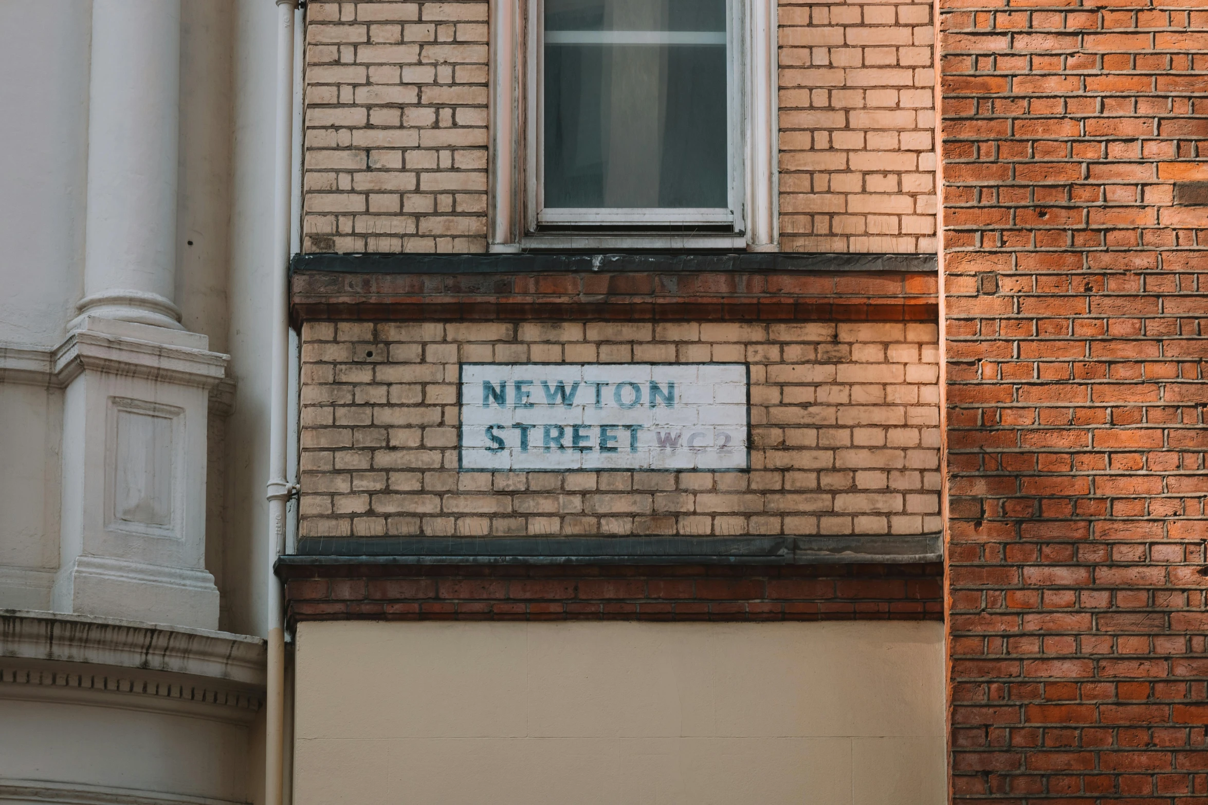 the brick building has a sign for newton street