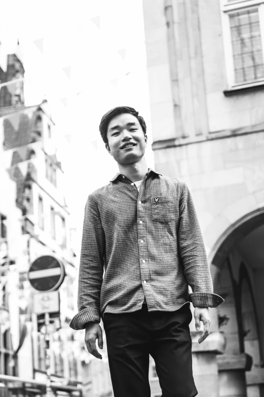 black and white image of a man standing in an urban setting