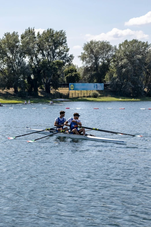 two rowers in a row on a body of water