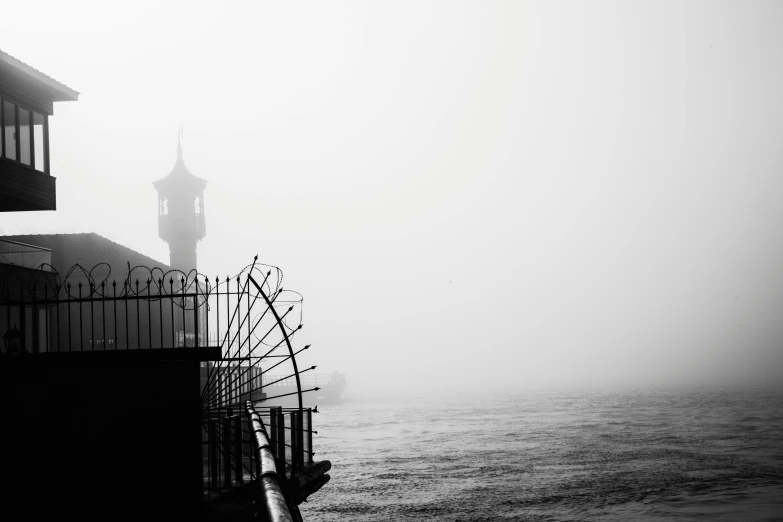 black and white pograph of a lighthouse on the water