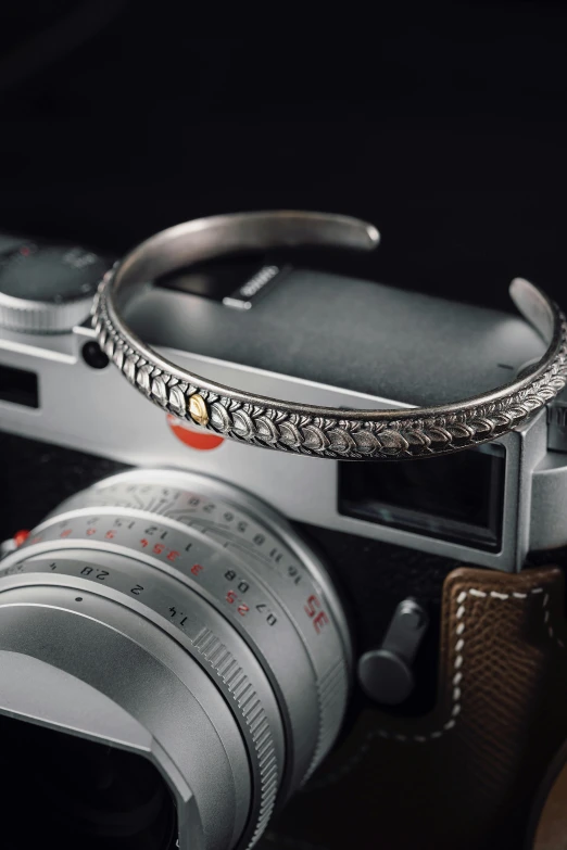 a camera is shown with some jewelry hanging from it