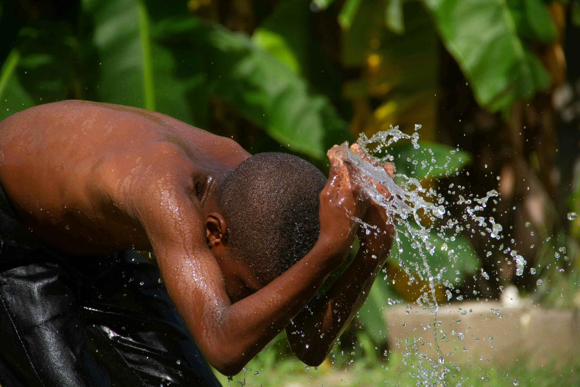 a man is splashing his face with water