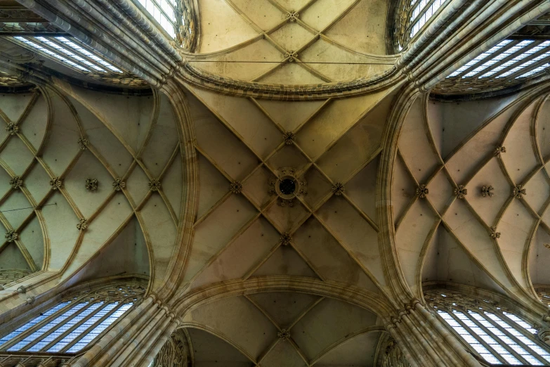 the ceiling of an old building has windows in it