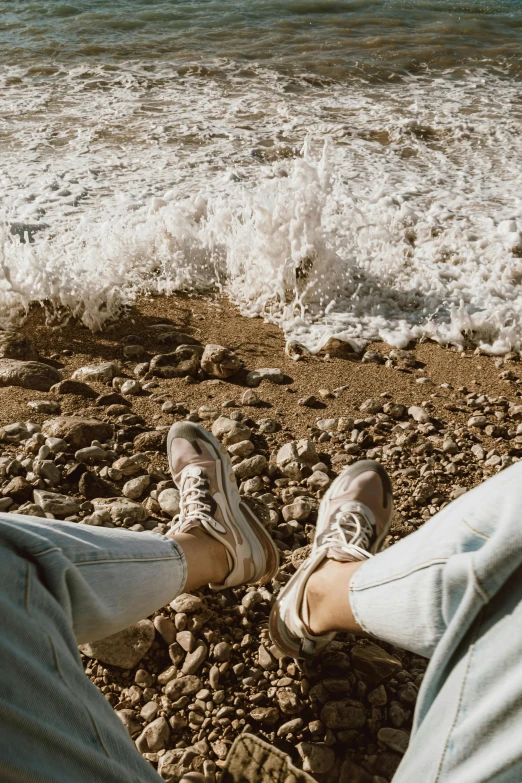 two people sitting next to each other on rocks