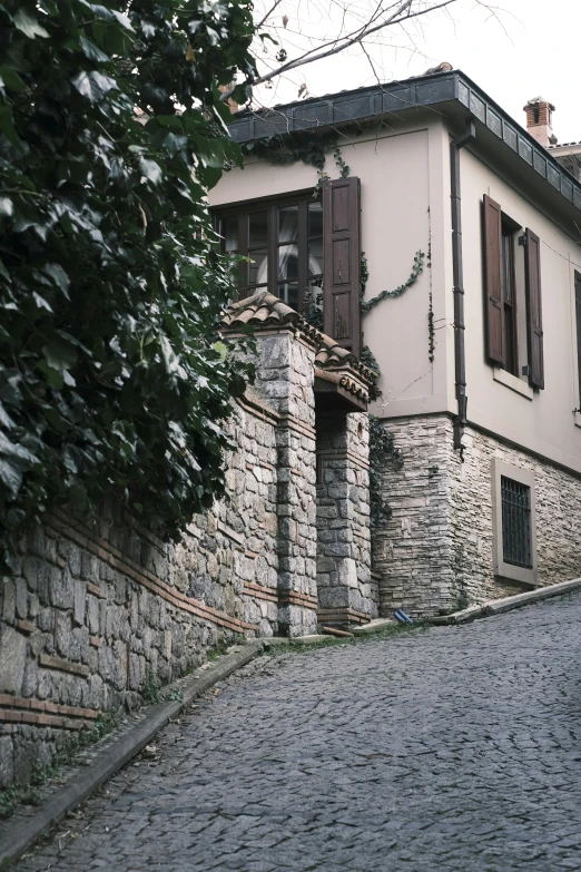 cobble stone road with large building in background