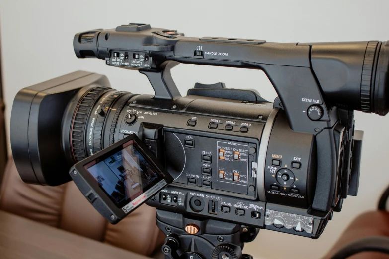 a video camera set up with a camera and tripod attached to it