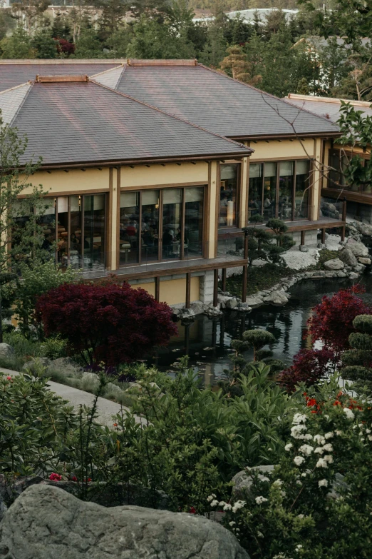 an elegant house sitting near a water garden