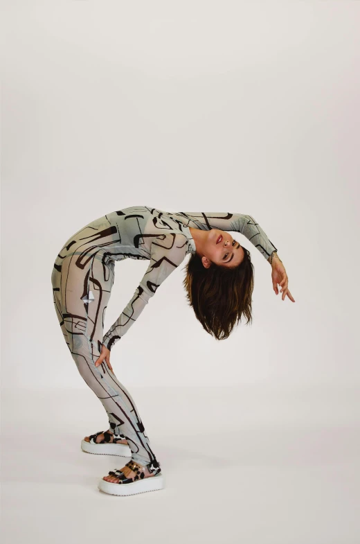 the young woman is bending down on her skateboard