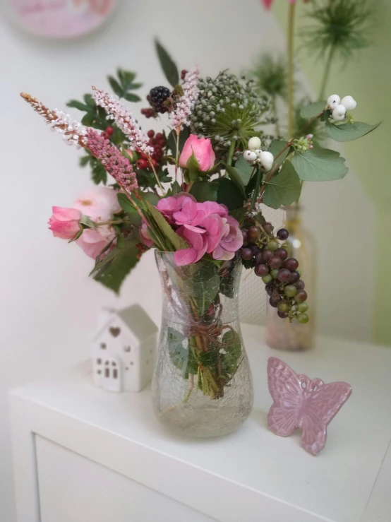 a glass vase filled with different colored flowers