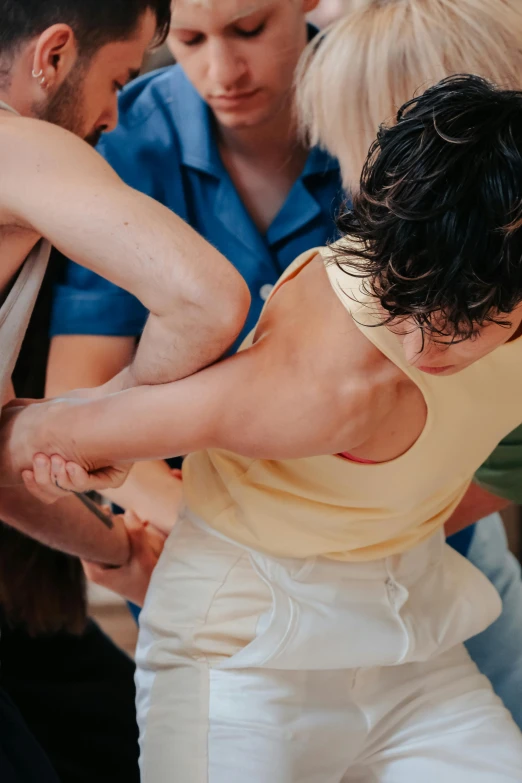 a person in a yellow top holding soing in their hands