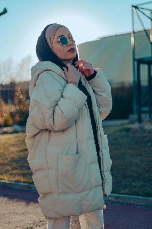 woman with sunglasses holding cell phone to her ear