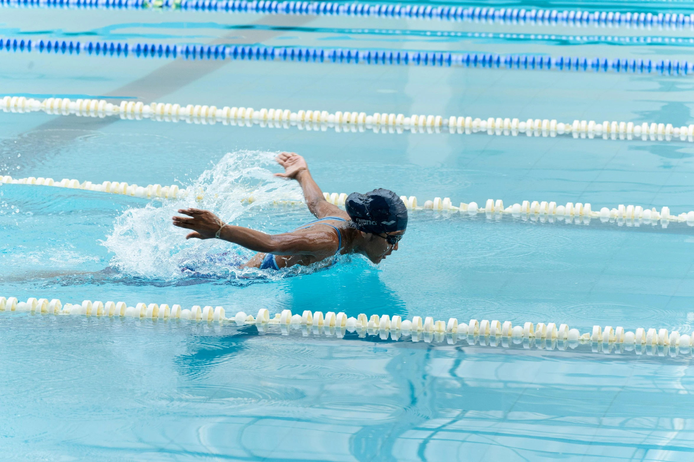 two swimmers are in a pool during the day