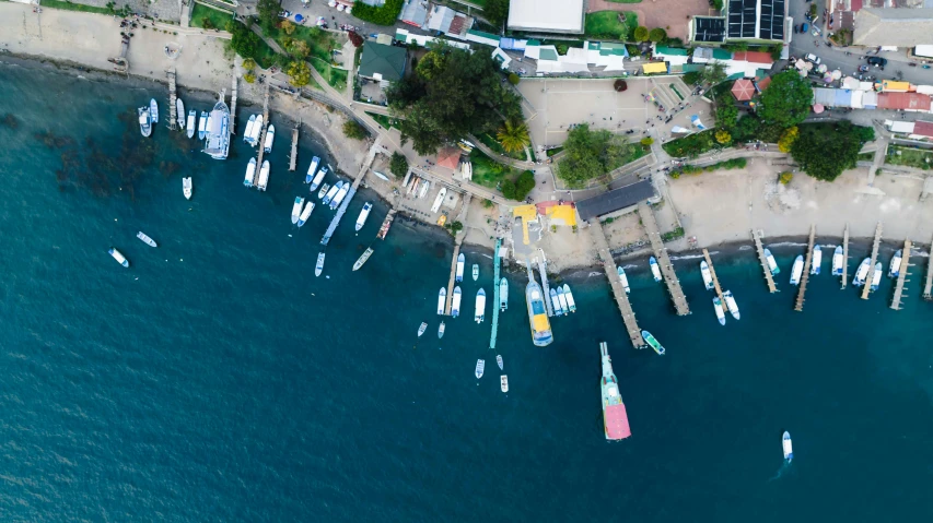 an aerial view of many sailboats in a marina