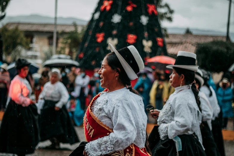 two women walk in the street dressed in costume