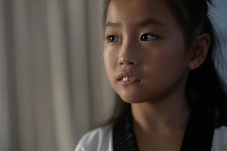 an asian girl poses in a dark room