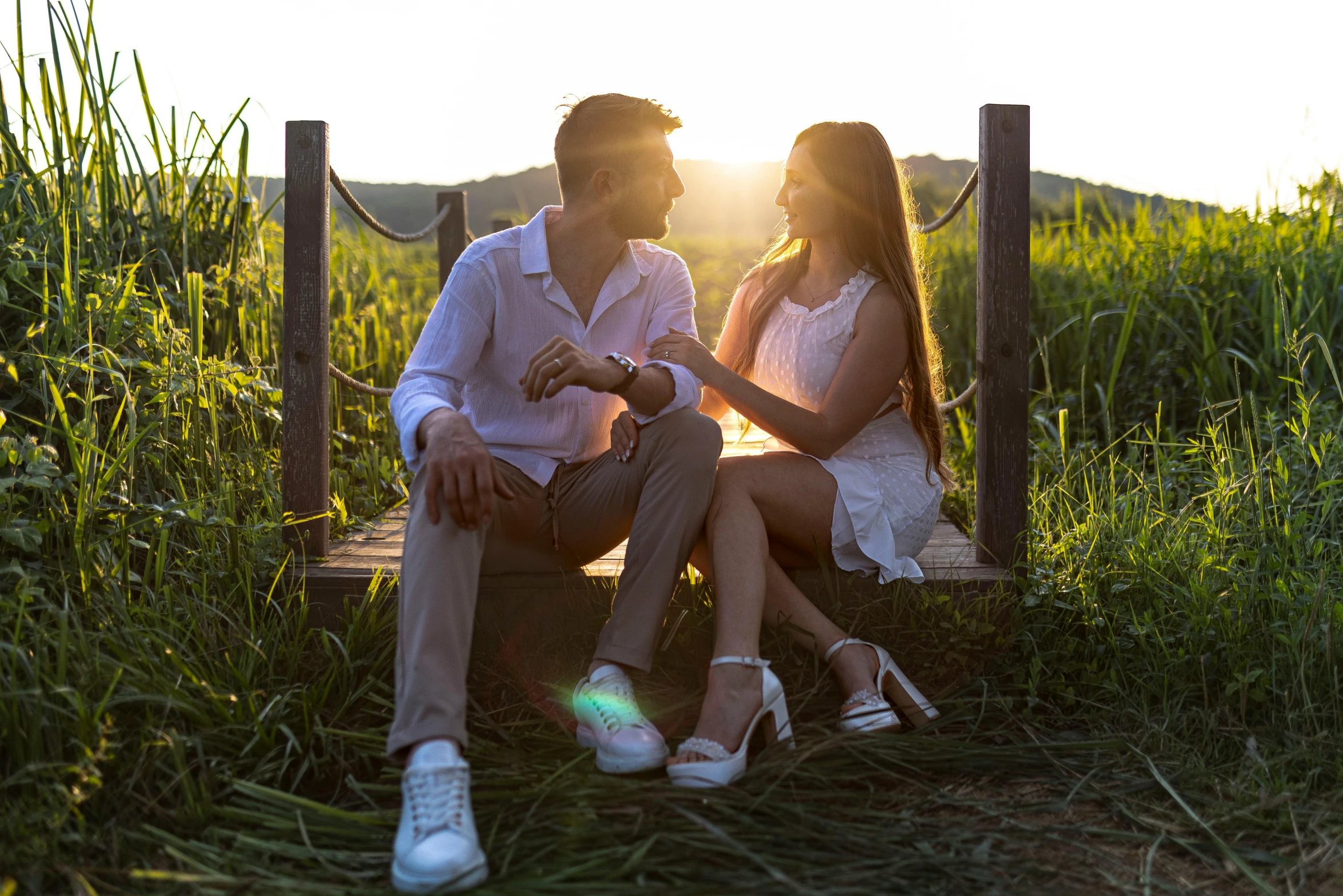 a man and a woman sitting together on a bench