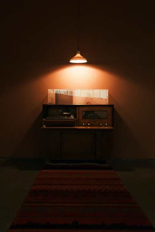 a lamp sitting on top of a table with an old fashioned radio