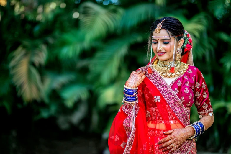 a beautiful young woman in an indian bridals outfit