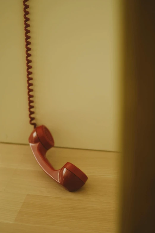 an old fashioned telephone sitting on top of a wooden floor