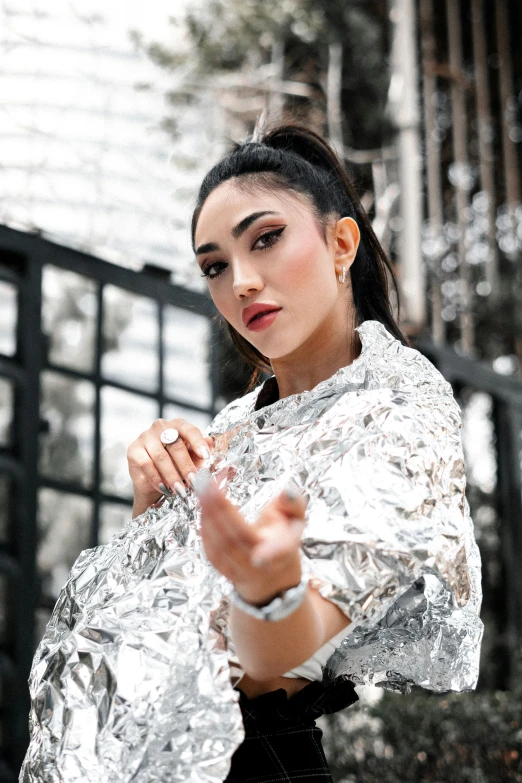 a woman dressed in tin foil poses for the camera