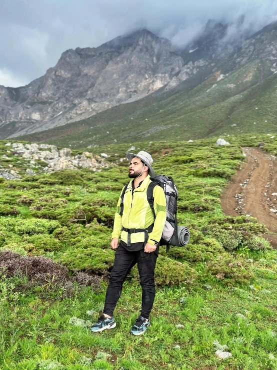 a person standing on top of a lush green field