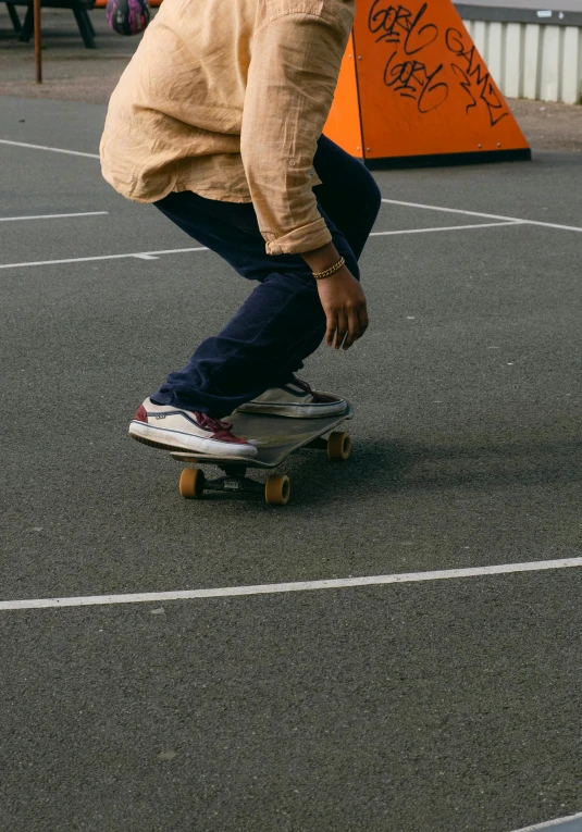 a man riding a skateboard down a parking lot