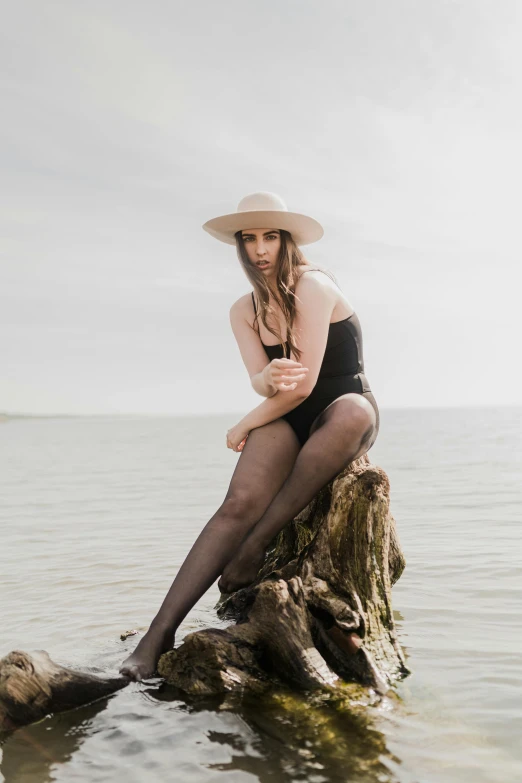 the young lady is posing on the water