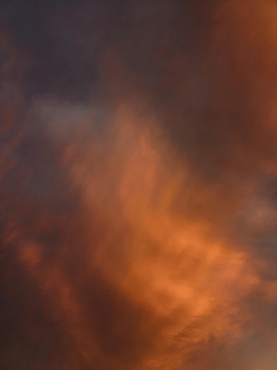 the sky is cloudy and there is a plane in the middle of the image