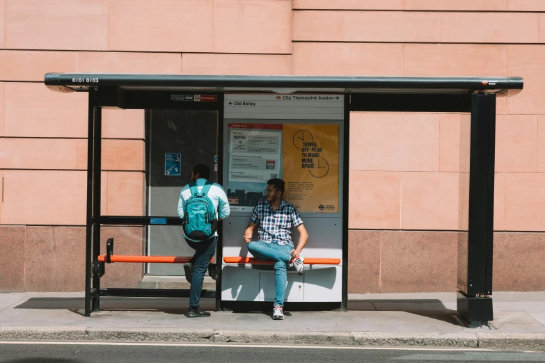 two men standing on and off a public transit bus