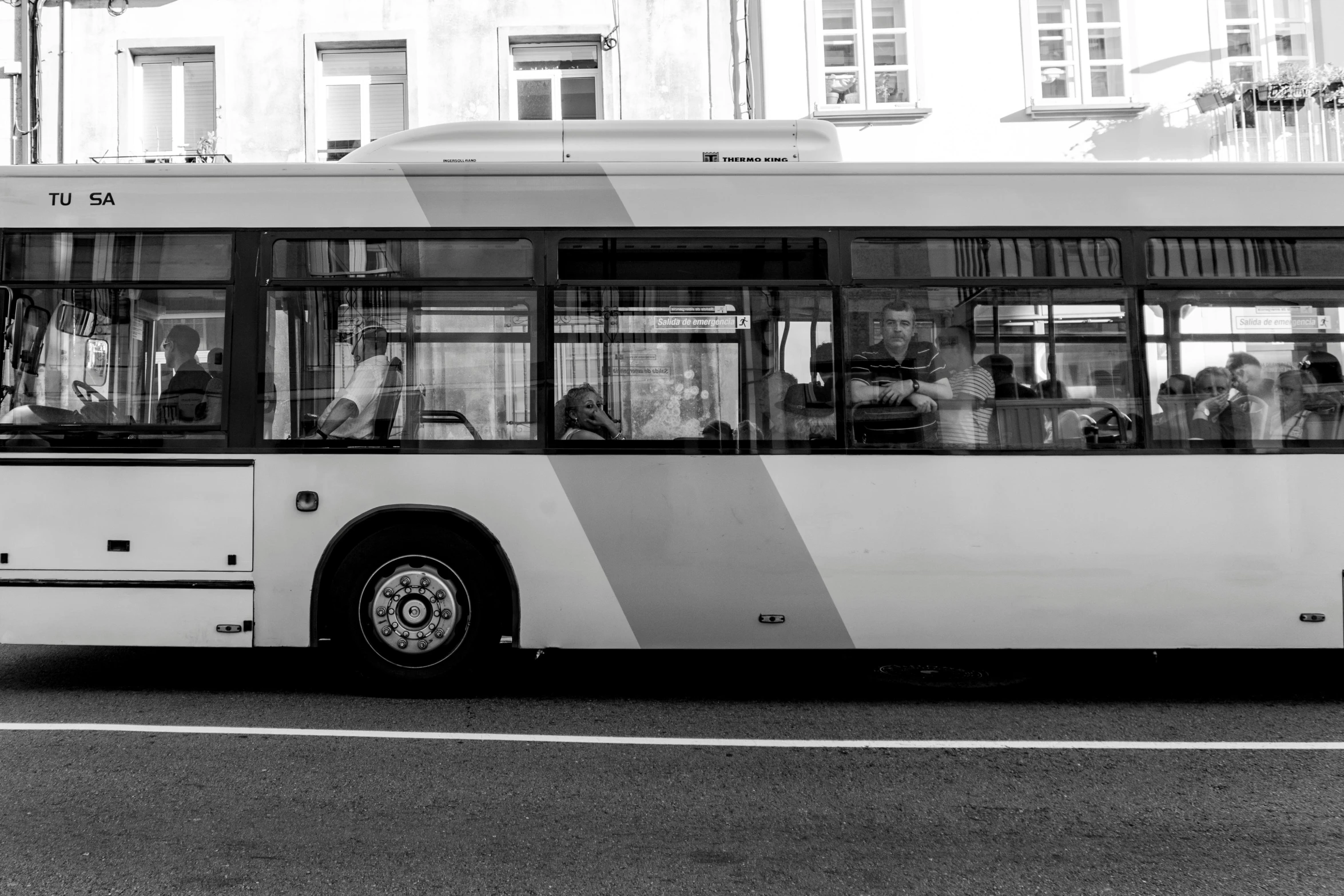 an old public transit bus parked at a bus stop